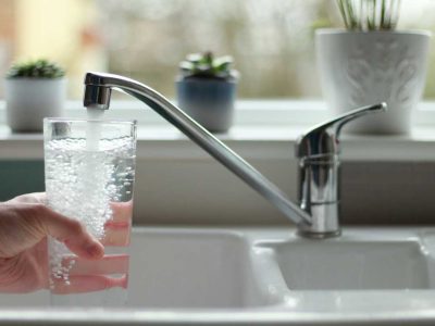 water-being-poured-into-glass-from-kitchen-tap